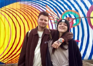 Christian with his arm around Grace