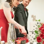 couple cuts wedding cake