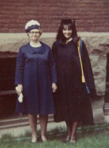 donna in a graduation gown standing next to her mother