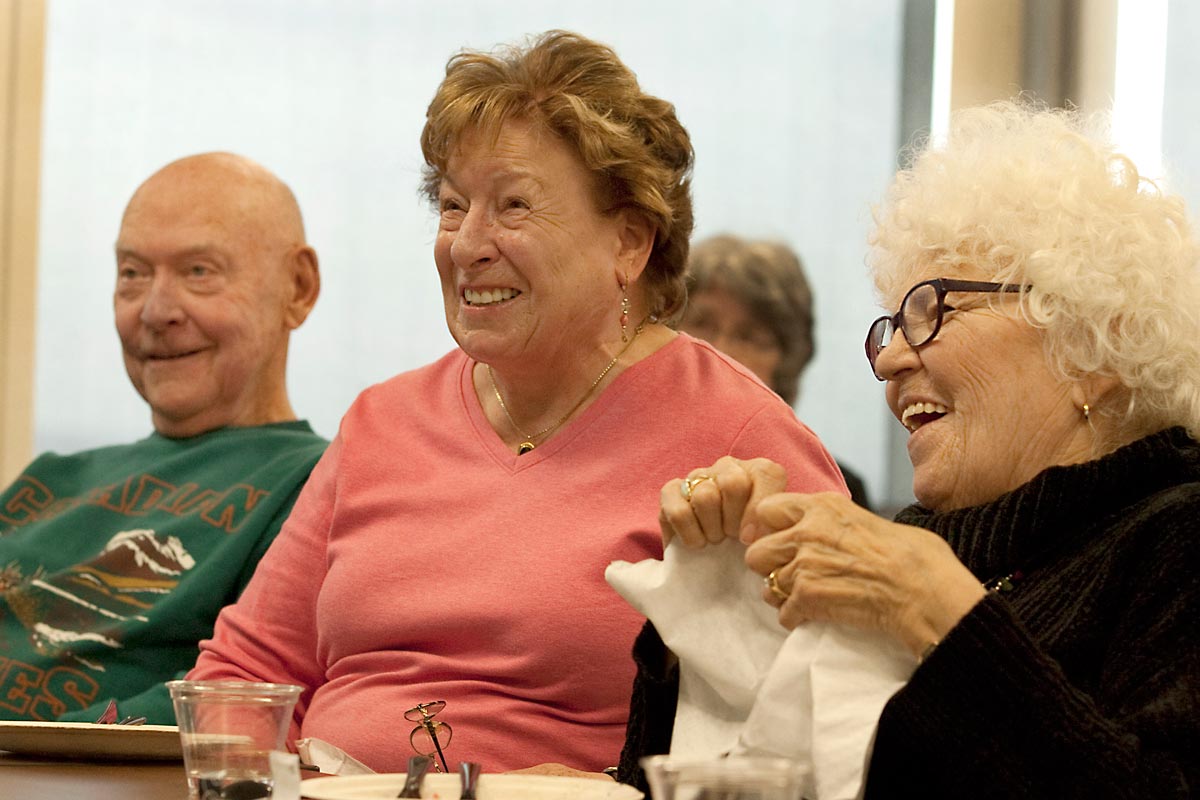 man and two women laughing during a longmont seniors program
