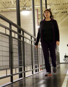 Hispanic women walking on indoor track