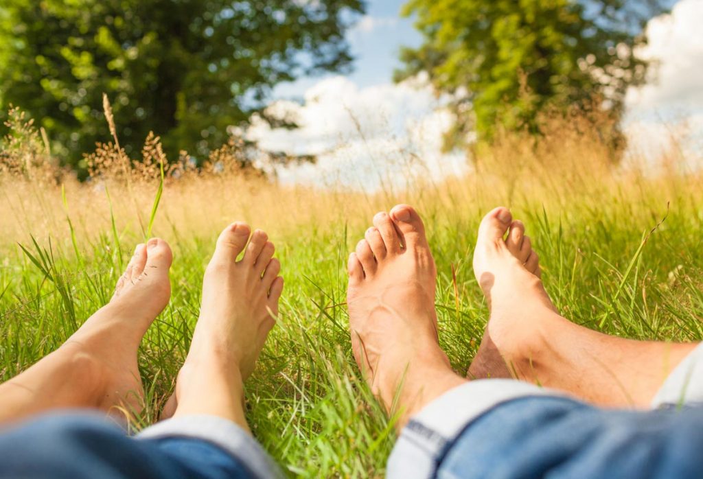 A picture of bare feet in tall grass.