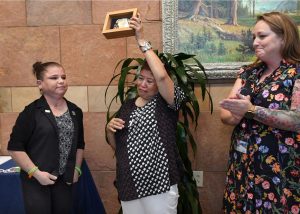 Ruth Sena holds up a rodeo belt buckle during a ceremony to honor organ donors.