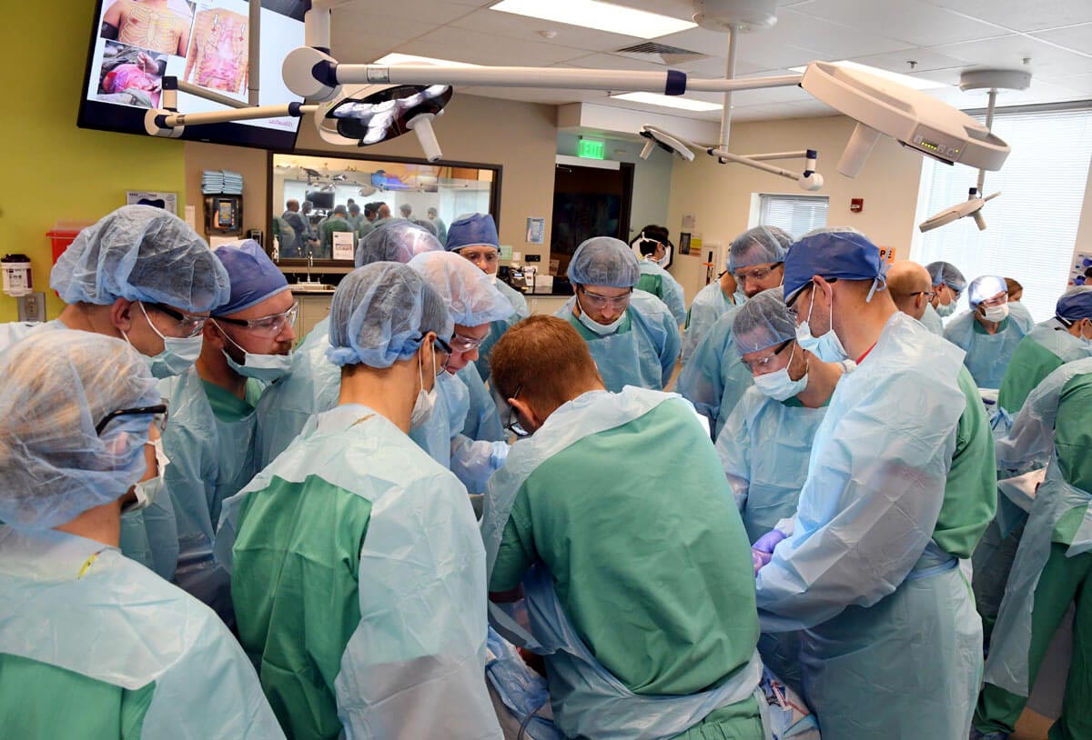 many FBI agents around an operating table