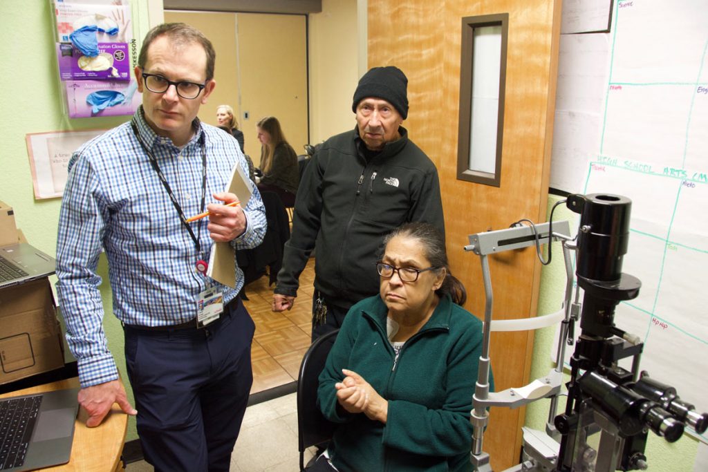 Dr. Frank Siringo consutls with uninsured patients in a makeshift exam room at the DAWN Clinic for uninsured people in Aurora.