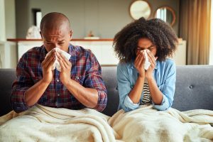 A photo of people with kleenix's to their noses who could be seen by an online doctor.