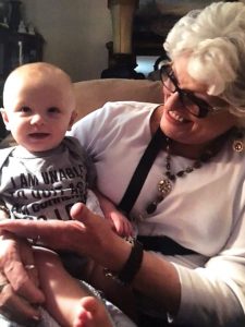 A grandmother holding her grandbaby.