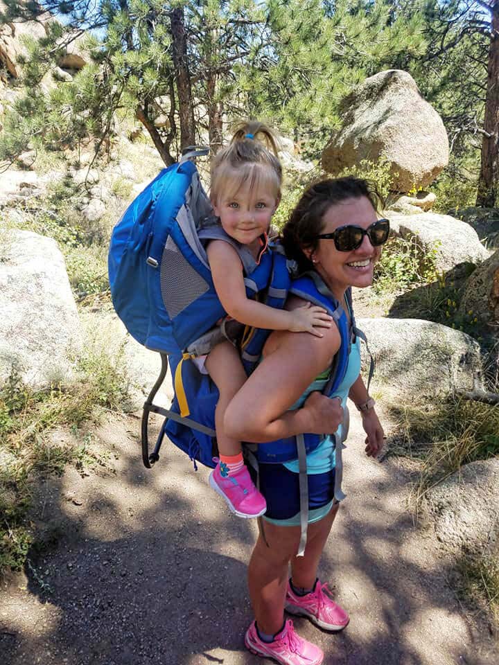 toddler in a backpack on moms back
