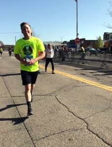 Kyle running down street in old town fort collins.