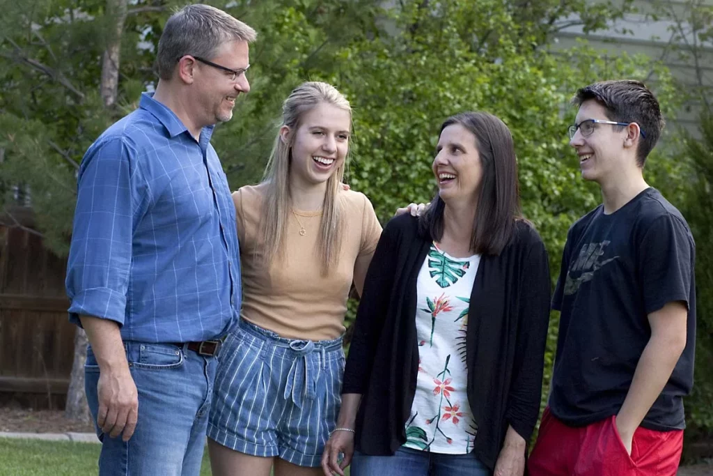 family standing outside together laughing