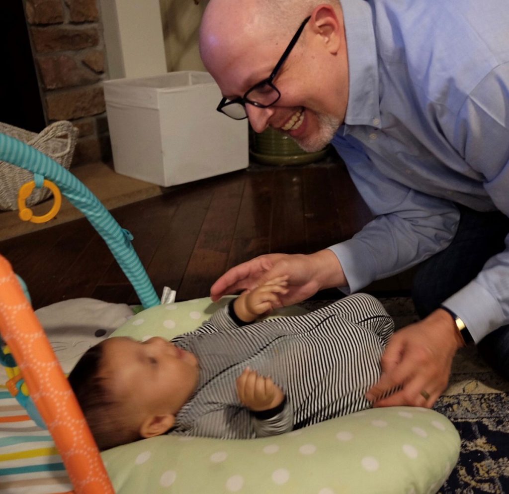 Michale Rector plays with his son Theodore.