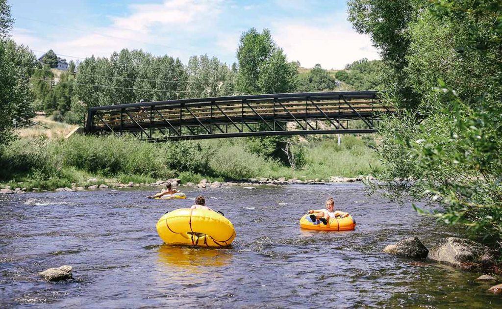 tubers float on a Colorado summer tubing river.