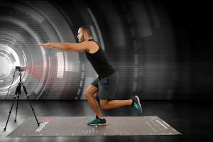 An athlete is video-taped performing exercises in this photo.