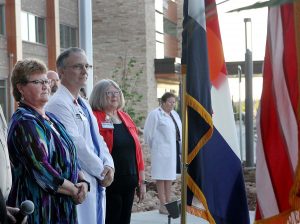 leaders stand looking at the flags
