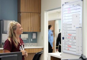nursing looking at white board.