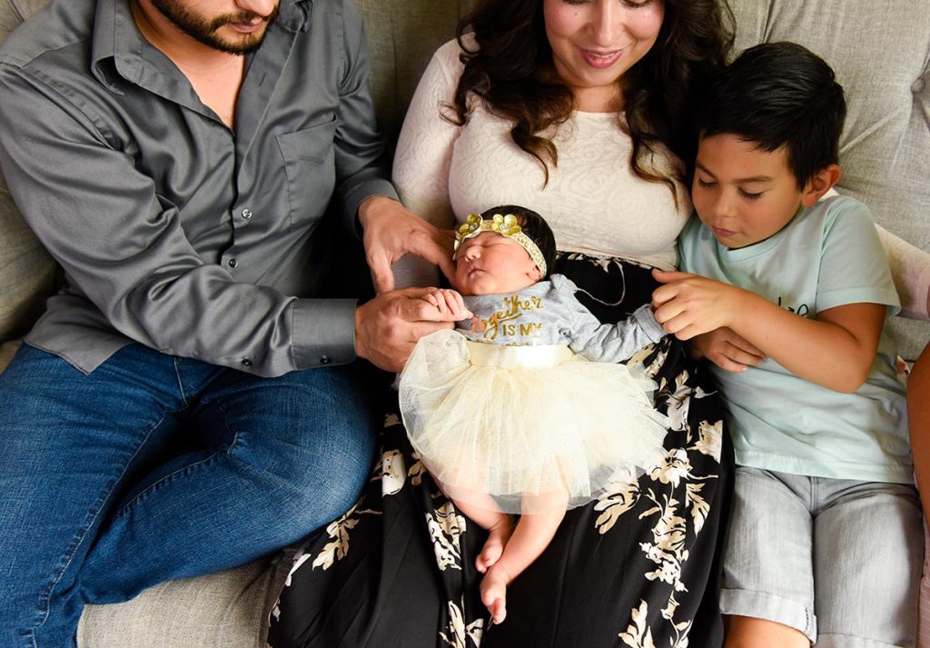 A couple with their two youngest children, a 5-year-old boy and a 3-day-old daughter.
