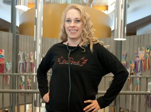 Brandi, a two-time living donor, standing at her school.