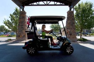 women in golf cart outside medical fitness building