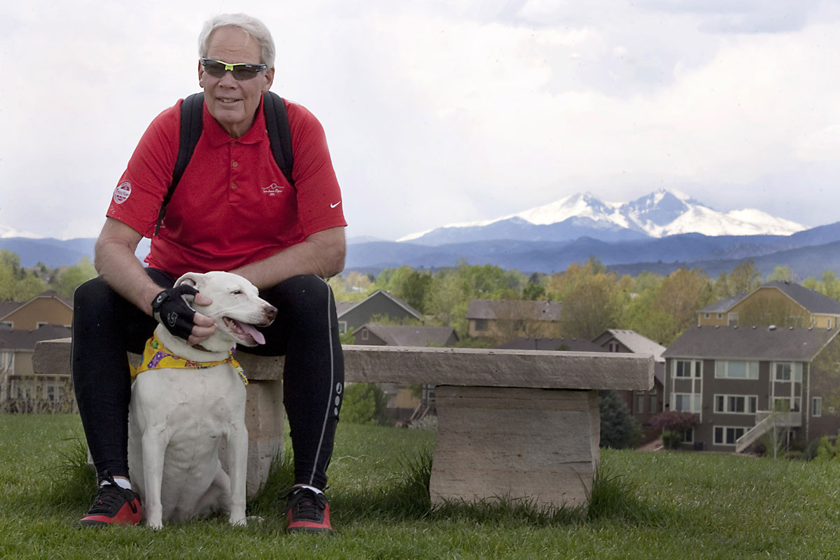 Steven Rutledge sits on a bench with his dog after having a procedure to correct an abnormal heart rhythm.