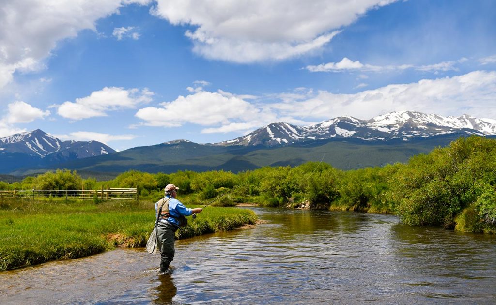 Fisherman Charles Duke casts in a tributary of the Arkansas River with Mt. Massive in the background.