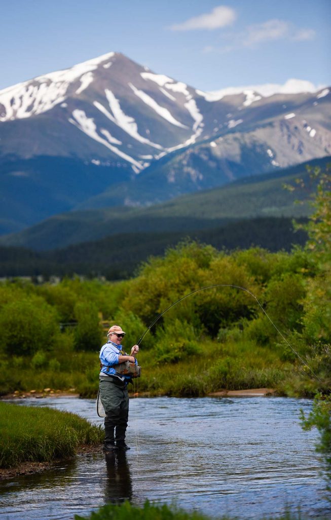 Charles Duke fishing in a tributary of the Arkansas River