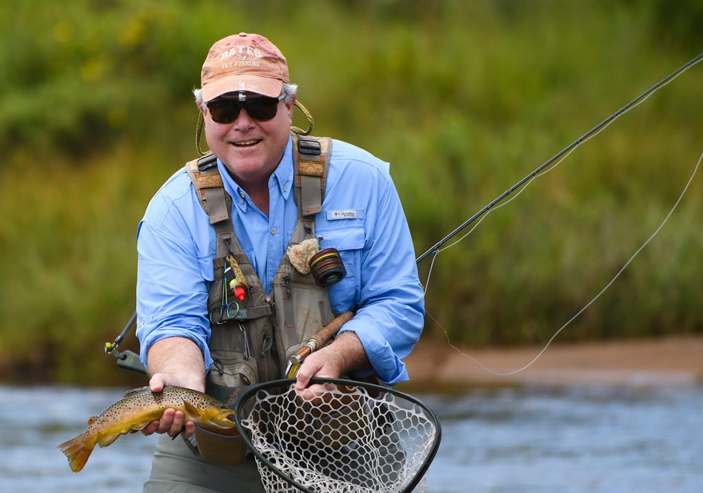 Charles Duke shows off a fish. He throws every fish back.