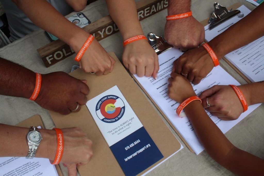 eight hands with bracelets to end overdoses in Colorado