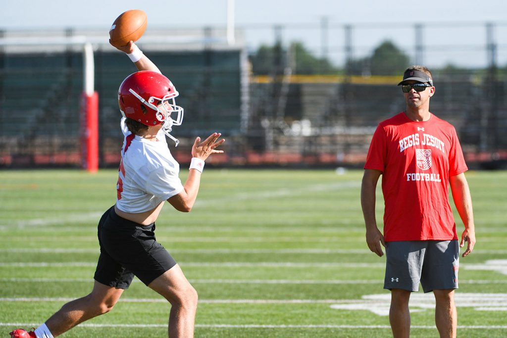 High school quarterback Nicco Marchiol works on his throwing with his Regis coaches. He's been working on sports performance.