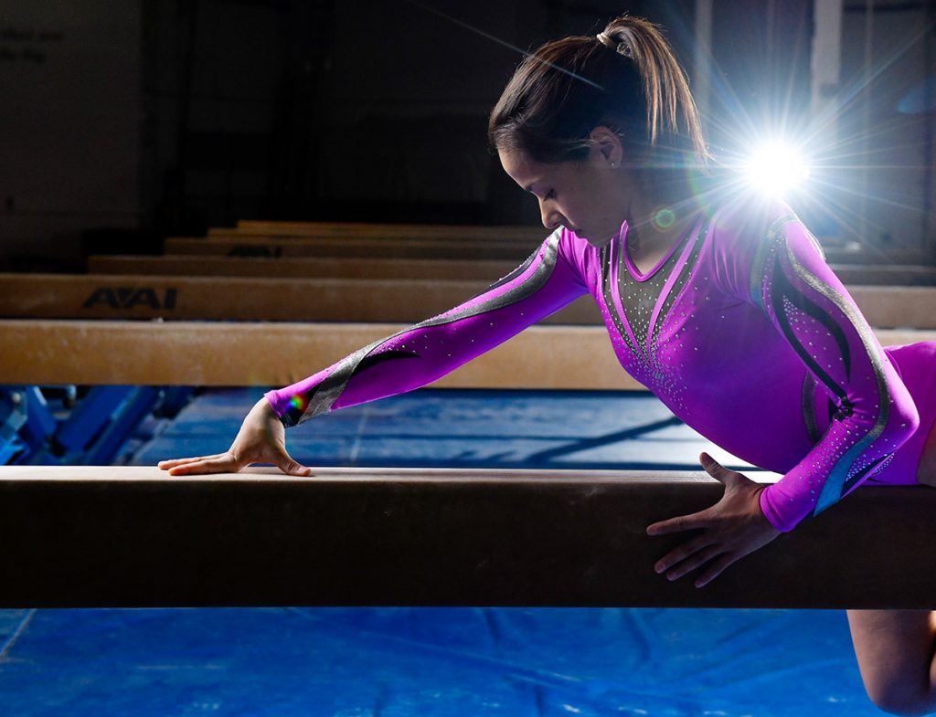 Olympic gymnast Jessica Lopez poses on the balance beam.