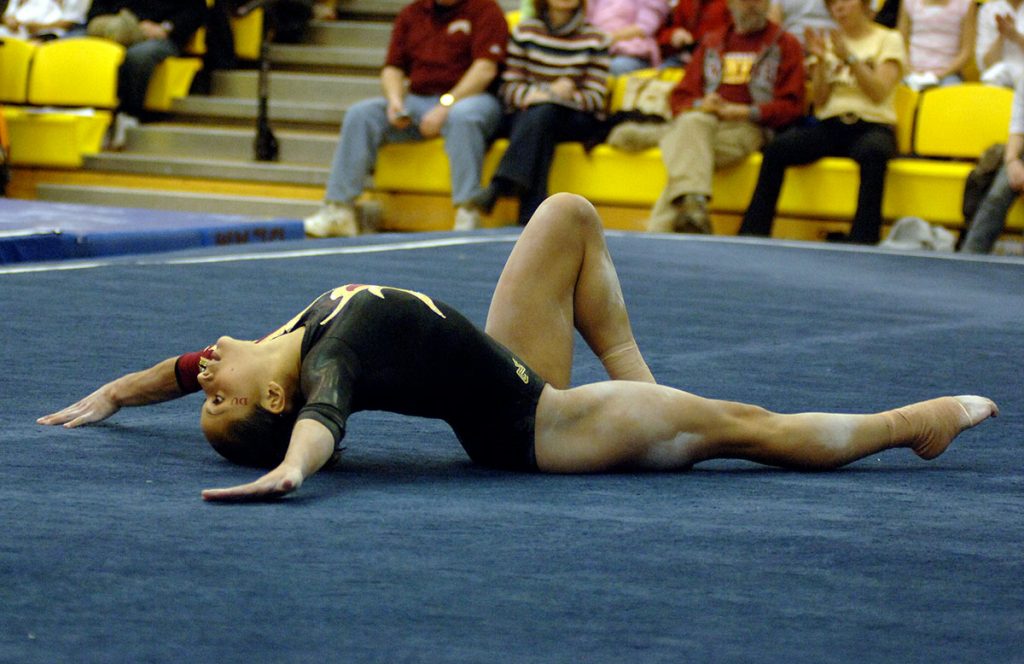 Olympic gymnast Jessica López competes in floor exercises during college.