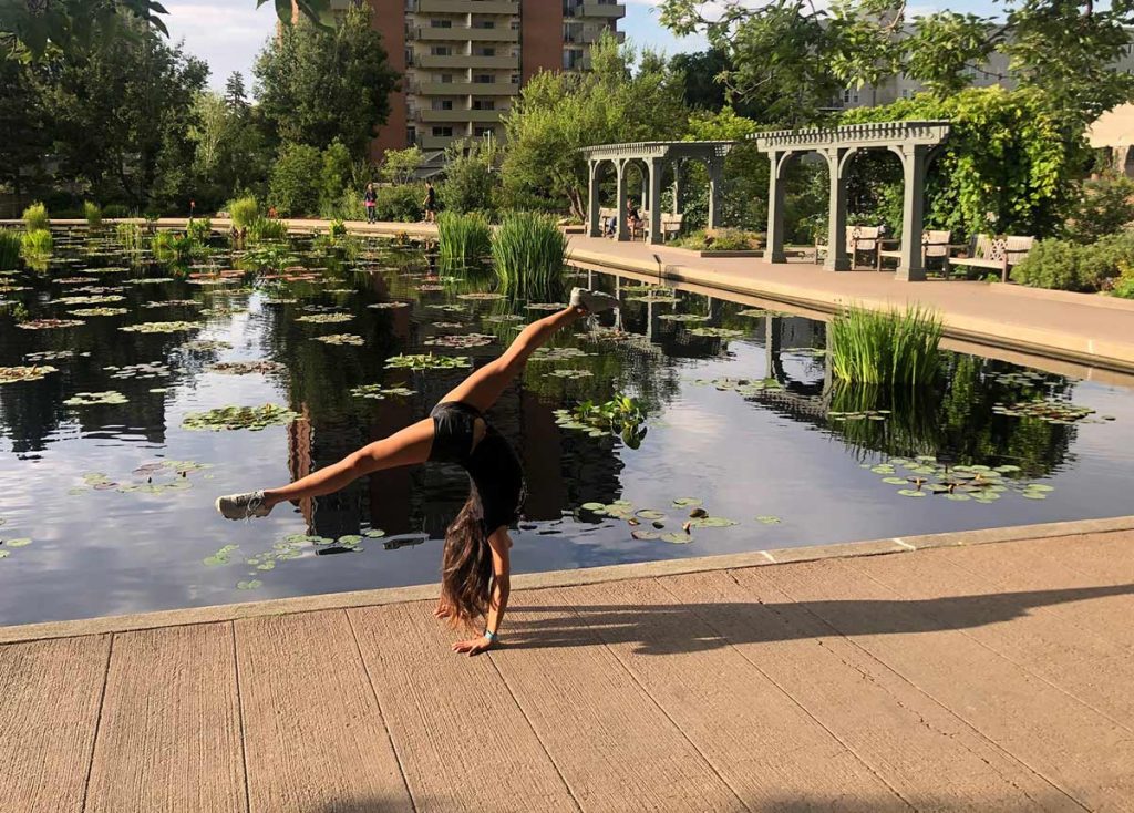 Olympic gymnast, Jessica López, shows off a handstand at the Denver Botanic Gardens