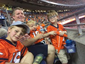Oliver Durkee with his brothers at a Bronco game