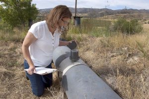 Kim looks at a water meter reading 11 months after her brain tumor was removed.