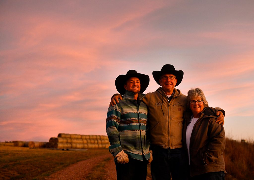 Rancher and cancer survivor, Nathan Kissack with his mom and dad, Bart and Kathy Kissack, at sunrise in Wyoming.
