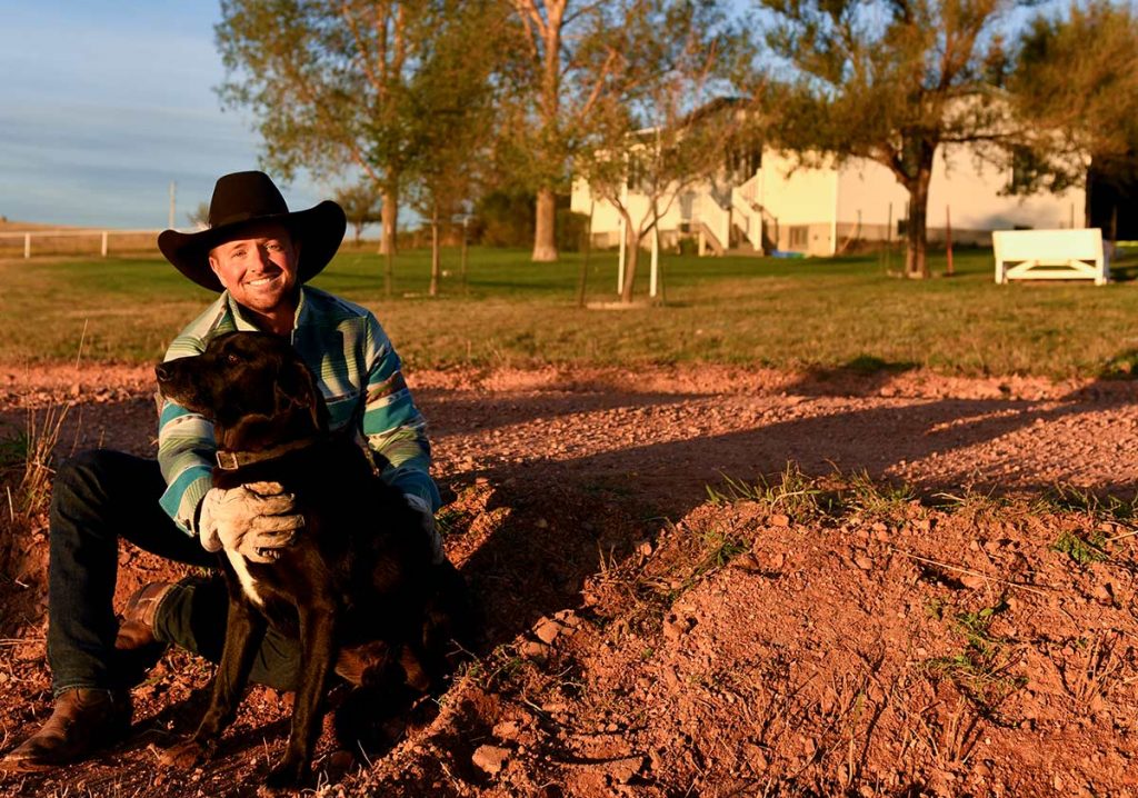 Rancher Nathan Kissack with his black lab, Nightlinger.