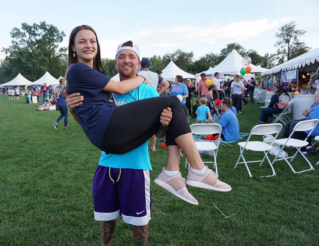 Rancher and cancer survivor Nathan Kissack holds one of his nurses, Danielle McAvoy, in his arms during the Light the Night celebration at Washington Park in September, 2019 in Denver.