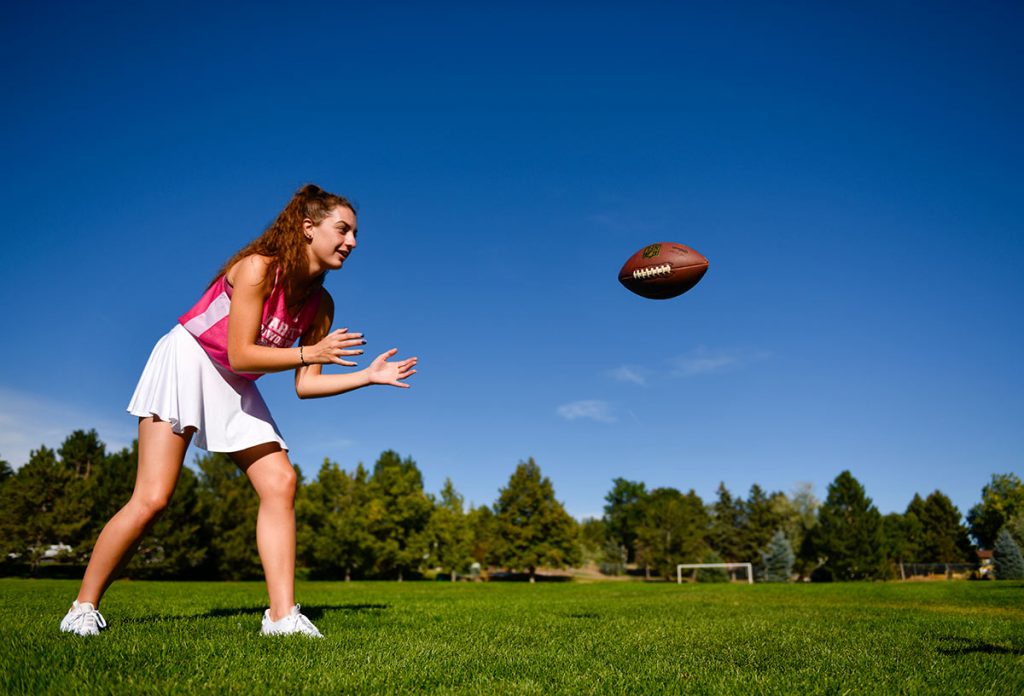 Ella Johnson anticipates catching a football, which has been thrown her way.