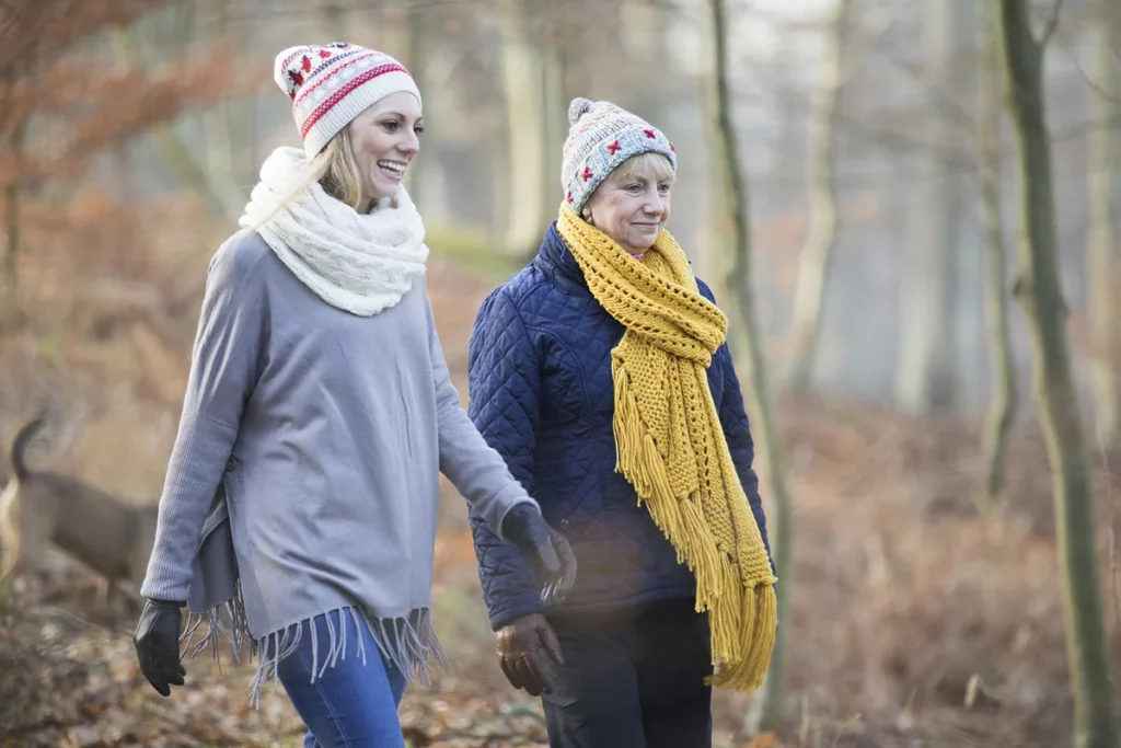 Two women take a walk during the fall in this photo.