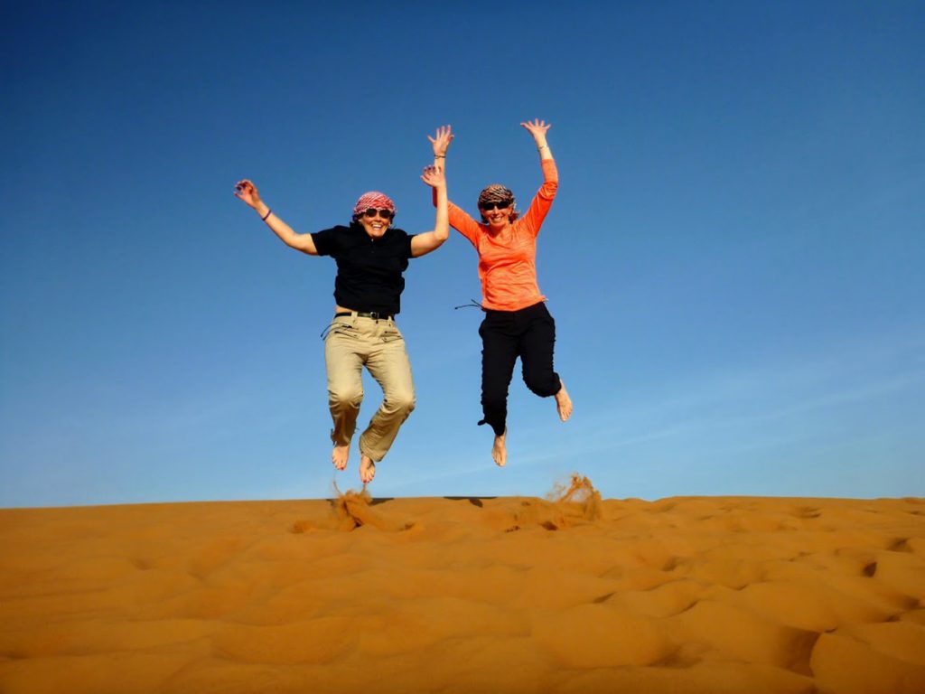 Surviving pancreatic cancer. Marybeth Hoffman jumps in the sand on a trip to the Middle East with her wife, Terry.