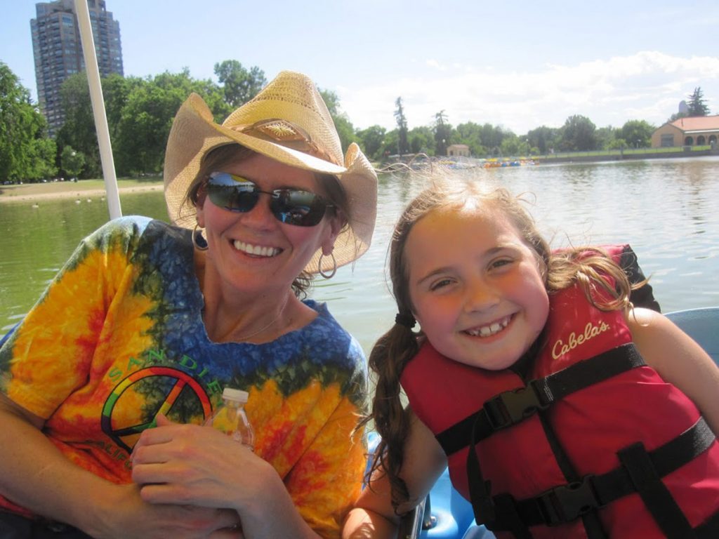 Marybeth Hoffman, who is fighting pancreatic cancer, poses with her niece. They are sittign in a boat.