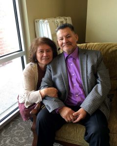 husband and wife take a photo together.