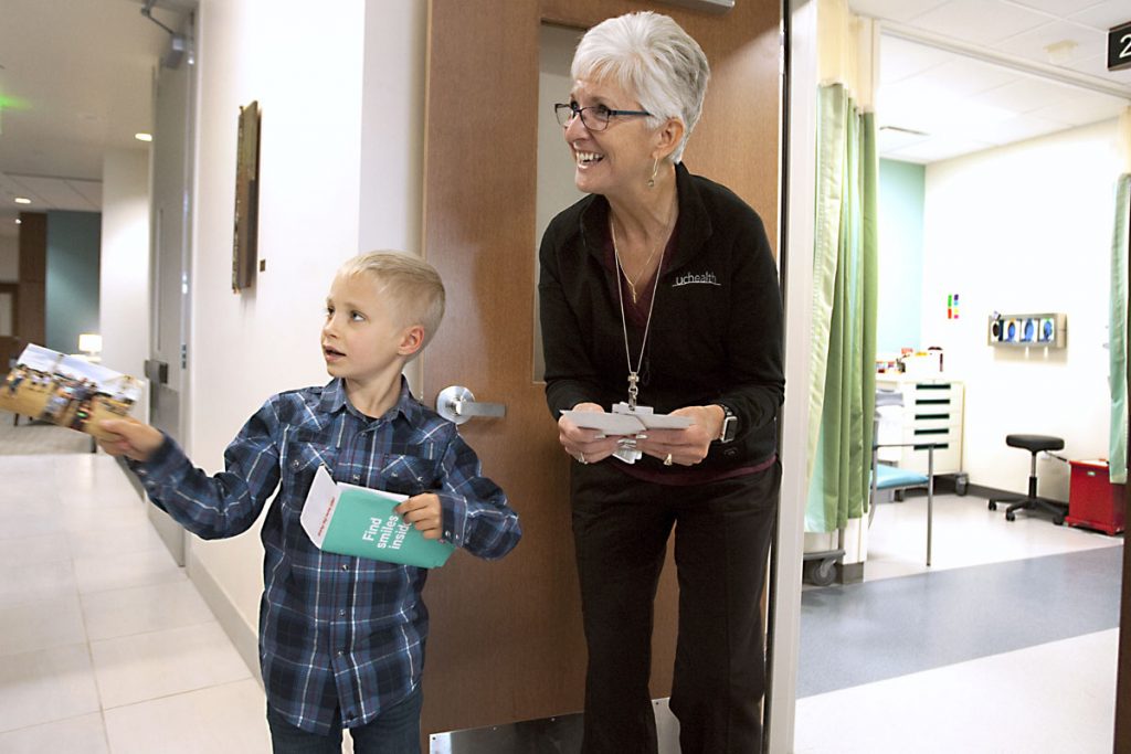 Boy meets his friend the phlebotomist, sharing photos with her at the hospital.