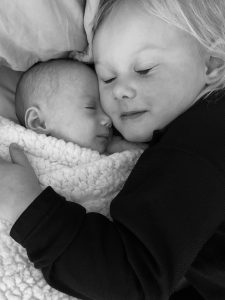In this photo, Eddy McDaniel snuggles her baby sister, Mimi.