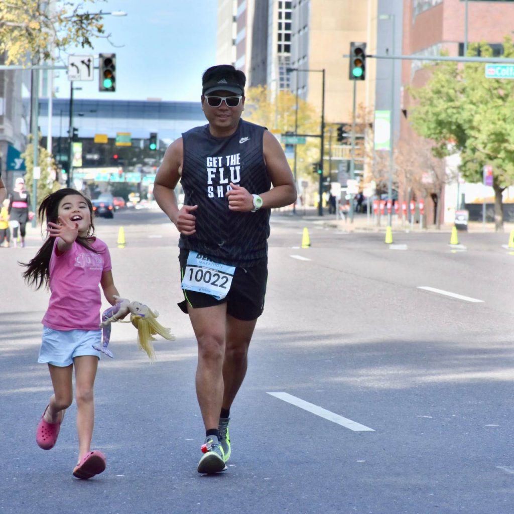 Victor running a 2015 Denver marathon after EMCO for acute respiratory distress syndrome saved his life. His 7-year-old daughter runs beside him.