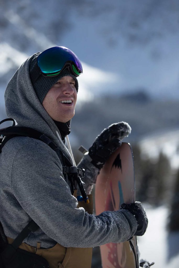 Jon Blank with snowboard near Loveland Pass after being able to enjoy the things he loves again after deep brain stimulation for OCD..