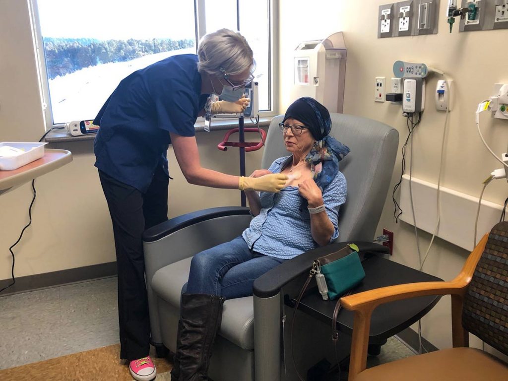 Nurse Heidi Swanson provides care for patient Mary Scott.