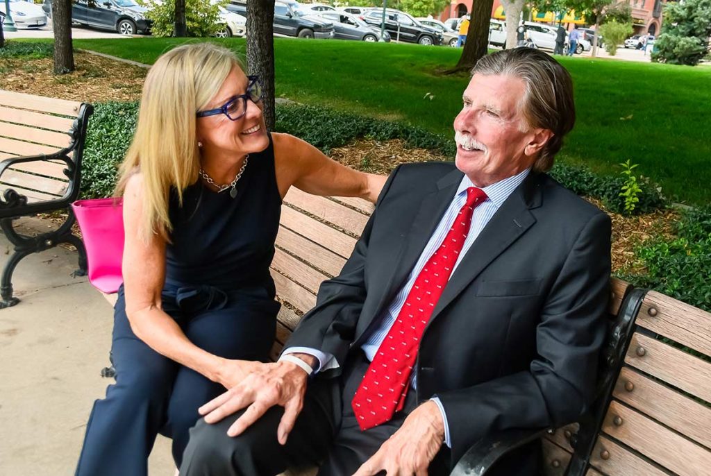 Mimi and Chester Wheeler sit on a bench outside the Pioneers Museum in Colorado Springs