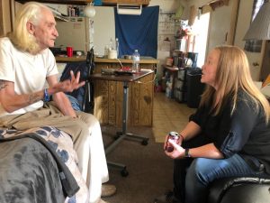 former patient and Hospital to Home program employee talk at trailer home in Colorado Springs.