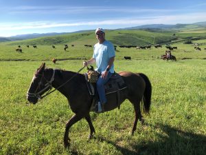 A man rides a horse in this photo.