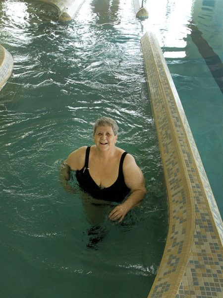 Margaret walks in the lazy river, a good prehabilitation for elective surgeries according to the Impact Clinic.